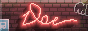 a red neon sign with the text doe, which flickers on a brick wall
